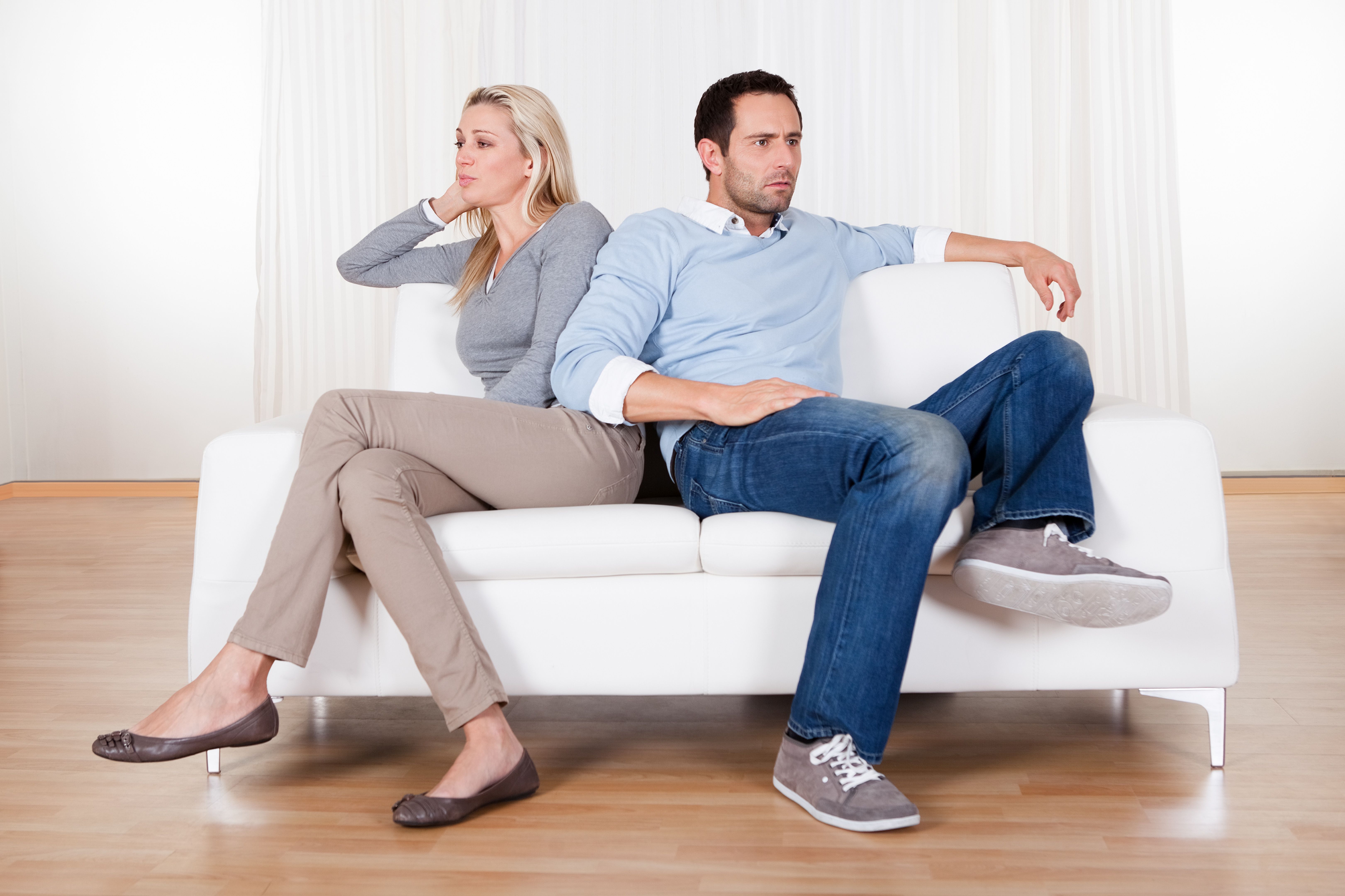 Madison, WI couple on couch mad at one another